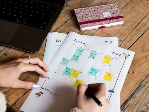 Handwritten notes and a calendar on a desk