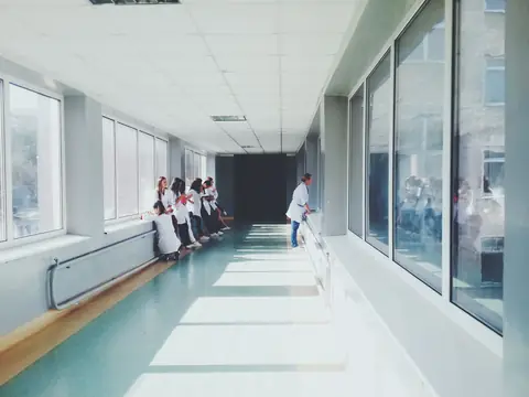 A quiet hospital corridor in soft daylight