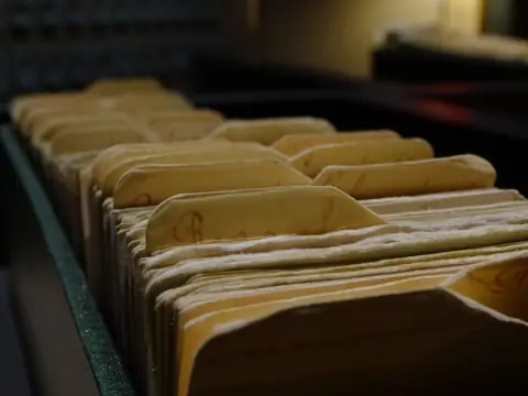 Paper record folders packed in a file drawer