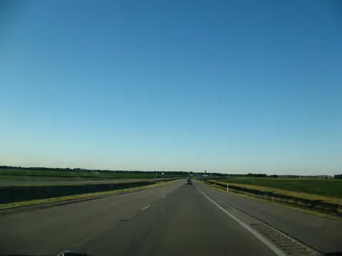 The divided US 24 highway between farm fields east of New Haven